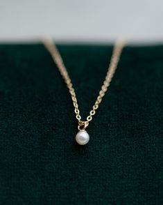 This Mini Pearl Pendant Necklace is the perfect complement for your evening wear or casual wardrobe. Crafted from 14k gold, this delicate necklace features a small cultured pearl, lending it a minimalist and elegant look. With this classic and versatile accessory, you're sure to make a statement. Pearl size: 2.75-3mm 14k Yellow Gold Classic 14k Gold Necklace With Pearl Charm, Minimalist 14k Gold Pearl Pendant Necklace, Minimalist 14k Gold Pearl Necklace, Minimalist Akoya Pearl Necklace For Formal Occasions, Minimalist 14k Gold Pearl Necklace With Pearl Charm, Dainty Pearl Charm Necklace For Formal Occasions, Minimalist Akoya Pearl Pendant Necklace, Classic Pearl Necklace With Delicate Chain For Formal Occasions, Classic 14k Gold Pearl Chain Necklace