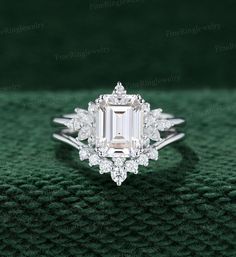 an emerald colored diamond ring with white diamonds