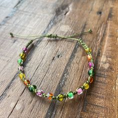 a close up of a bracelet on a wooden surface