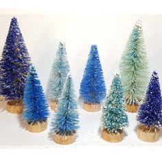 small blue and green christmas trees on wooden bases