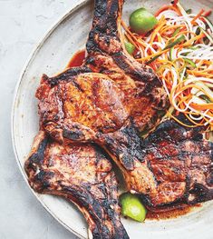 a white plate topped with meat and veggies