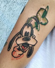 a person with a goofy duck tattoo on their arm