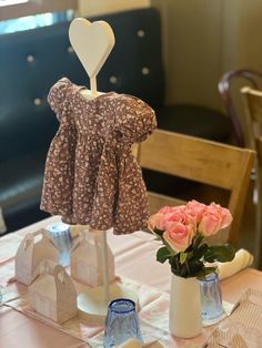 two vases filled with flowers sitting on top of a table