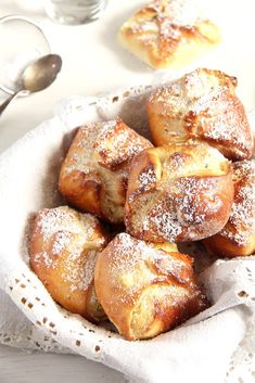 a basket filled with pastries covered in powdered sugar