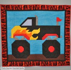 a wall hanging made to look like a monster truck with flames on the front and back