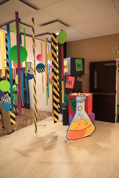 an office decorated with brightly colored paper and streamers in the shape of beaks