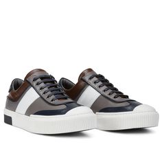 This leather lace up sneaker has been handcrafted from flawless grain leather, embellished with a leather insole that nods to the brand's heritage. Perfectly paired with tailored suits and leather jackets. Leather Lining for a luxurious feel and moisture control Leather collar and tongue Rubber sole Tapered round toe. The handmade sustainable Gommus rubber outsole and insole are Made in Italy. STYLE #D2168T Classic Navy Sneakers With Contrast Sole, Navy Leather Lace-up Sneakers, Navy Leather High-top Sneakers With Branded Insole, Navy Leather Sneakers For Streetwear, Navy Low-top Custom Sneakers With Rubber Sole, Navy Leather Custom Sneakers For Streetwear, Sporty Navy Sneakers With Stitched Sole, Classic Navy Sneakers With Textured Sole, Navy Low-top Custom Sneakers With Cushioned Midsole