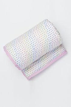 two pillows sitting next to each other on top of a white surface with polka dots