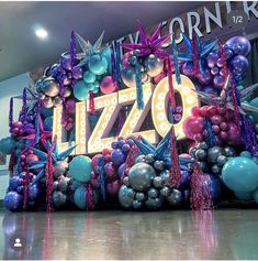 a large sign with balloons and streamers in the shape of letters that spell it's 70