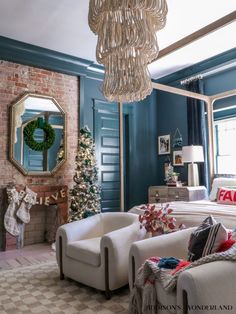 a living room filled with furniture and a christmas tree in front of a fire place