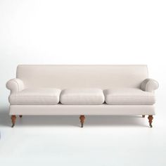 a white couch sitting on top of a hard wood floor