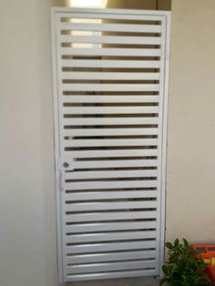 a white radiator sitting next to a potted plant