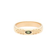 a gold ring with an emerald stone in the center and wings on it's side