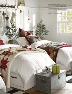 two beds in a room with christmas decorations on the wall