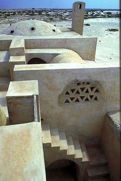 a building made out of cement in the desert