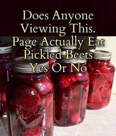 jars filled with pickled beets sitting on top of a table next to a sign that says does anyone viewing this page actually eat pickled bees? yes or no