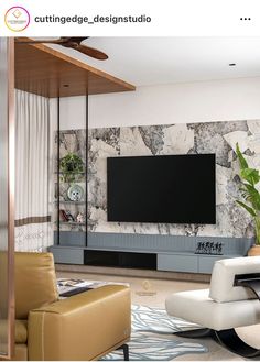 a living room with modern furniture and a flat screen tv mounted on the wall above it