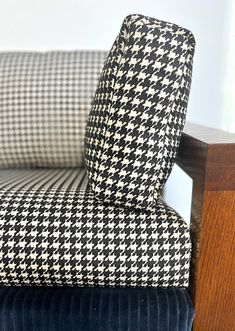 an upholstered chair with black and white checkered fabric