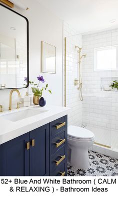 a white bathroom with blue and gold accents