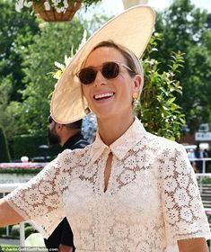 a woman wearing a large hat and sunglasses