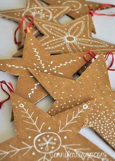 five brown star shaped ornaments with red string