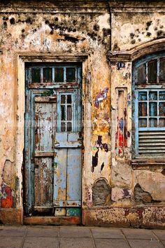 an old building with two doors and windows