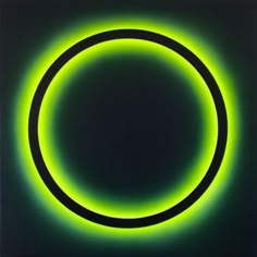 a black and green circle that is glowing in the dark