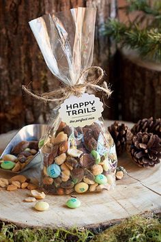 a bag filled with trail mix sitting on top of a tree stump