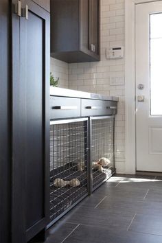 a dog cage in the corner of a kitchen