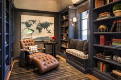 a living room filled with lots of bookshelves next to a desk and chair