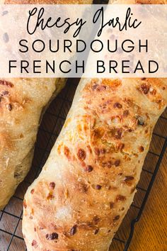 two pieces of bread sitting on top of a cooling rack with the words cheesy jalapeno sourdough french bread