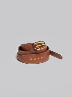 Belt in calf leather with stitching details in contrast. Gold hardware. 3cm height with buckle closure. Gold printed logo. Designer Leather Belt For Office, Elegant Formal Belts With Logo Hardware, Elegant Formal Belt With Logo Hardware, Designer Brown Belts For Workwear, Timeless Leather Belt For Office, Designer Belts With Gold-tone Hardware For Work, Leather Belts With Buckle Closure For Office, Leather Belt With Buckle Closure For Office, Timeless Leather Belts For Office