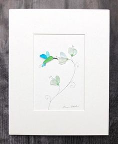 a white frame with a blue and green bird on it