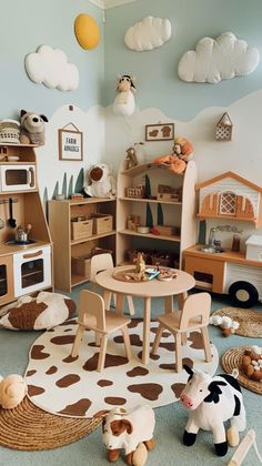 a child's playroom with toys and decor on the walls, including cow rugs