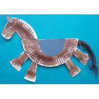 a horse made out of cardboard sitting on top of a blue surface