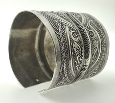 "Presenting a wonderful vintage, solid silver cuff BRACELET from Tunisia. The bracelet measures over 2 1/2\" (6,45 cm) wide and its inner diameter is 2 3/4\" (7,0 cm), though it is FULLY ADJUSTABLE. The bracelet features wonderfully textured floral and geometric designs. It has Tunisian and Libyan hallmarks for 800 silver. This piece is also an excellent size for a man's wrist." Handmade Antique Silver Cuff Bracelet For Ceremonial Occasions, Handmade Antique Silver Cuff Bracelet For Ceremonial, Ceremonial Antique Silver Cuff Bangle, Traditional Etched Cuff Bangle, Collectible Cuff Bracelet Bangle With Intricate Design, Collectible Cuff Bracelet With Intricate Design, Collectible Cuff Bangle With Intricate Design, Ornate Handmade Ceremonial Cuff Bracelet, Traditional Cuff Bracelet With Intricate Design