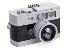 an old fashioned camera made out of legos on a white background with the lens up