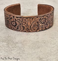 These gorgeous patterned copper bracelets are created using antique rolling plates from the Frank Morrow Cranston Fancy Wire Company in Rhode Island from 1867.    The pattern has a south western flower print on it. They are approx. 7 1/8th inches outer diameter, approx. 6 1/8th in on the inside and approx. 1 in wide. Adjustable Antique Cuff Bracelet With Antique Finish, Adjustable Antique Finish Cuff Bracelet, Bohemian Adjustable Cuff Bracelet With Antique Finish, Adjustable Bohemian Cuff Bracelet With Antique Finish, Antique Finish Adjustable Cuff Bracelet, Antique Engraved Cuff Bracelet, Antique Adjustable Cuff Bracelet With Patina, Antique Adjustable Cuff Bracelet With Intricate Design, Antique Stamped Adjustable Cuff Bracelet