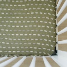 a green and white pillow sitting on top of a bed