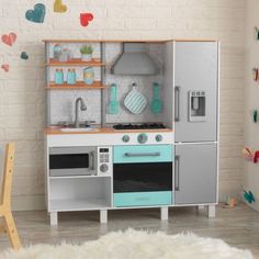 a child's play kitchen with an oven, stove and microwave