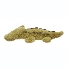 a stuffed alligator laying on top of a white surface