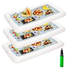 three white trays with food on them next to a marker and green marker pen