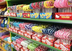 the shelves are full of candy and lollipops for sale at this store