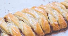 a pastry with icing sitting on top of a piece of paper