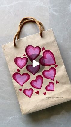 a bag with hearts drawn on it sitting on top of a white table next to a brown string