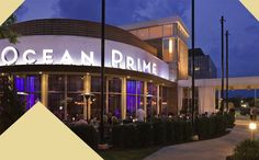 the ocean prime restaurant is lit up at night