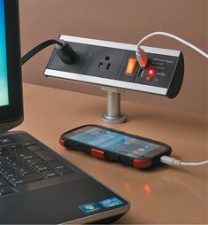 an electronic device is plugged into a laptop