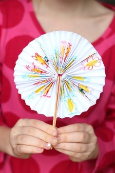 a hand holding a paper fan with the words cool and cute crafts for kids to make at home