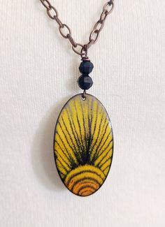 "This pendant is made with black, and yellow enamel torch fired onto a 2\" copper oval shape. I use sgrafitto technique to draw a sun pattern into the enamel before firing. The piece is shown on a chunky 30\" copper chain. You can attach lobster clasp anywhere on the chain to adjust length. Please remember - these pieces are custom made, which means the finished product may vary slightly from the photo." Draw A Sun, Torch Fired Enamel Jewelry, Enameling Jewelry, Terracotta Jewellery Making, Enamel Stud Earrings, Butterfly Wing Earrings, Terracotta Jewellery, Sun Necklace, Yellow Jewelry