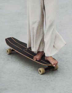 a person standing on top of a skateboard with their feet propped against the board